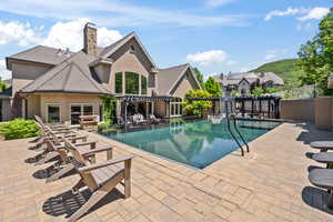 View of swimming pool featuring a patio and a pergola