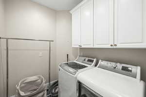 Clothes washing area with washing machine and dryer and cabinets