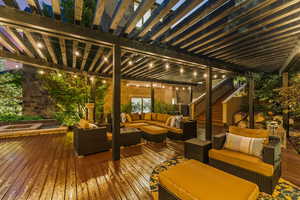 Wooden deck featuring a pergola and outdoor lounge area