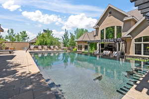 View of pool featuring a pergola and a patio area