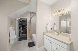 Full bathroom with tile flooring, shower / tub combo, oversized vanity, and toilet