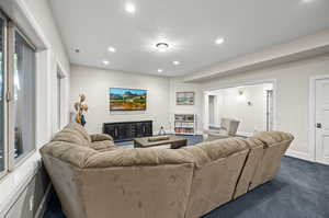 Living room with dark carpet and a textured ceiling