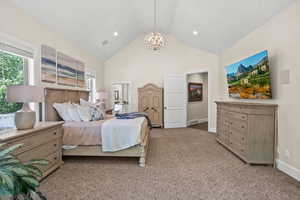 Bedroom featuring a notable chandelier and high vaulted ceiling