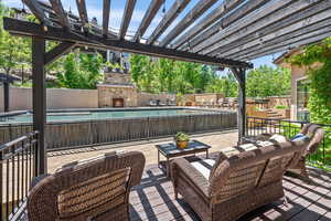 View of patio with a pergola, an outdoor hangout area, and a fenced in pool