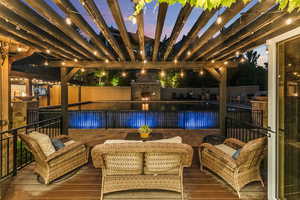 Exterior space with a pergola, an outdoor living space with a fireplace, and a fenced in pool