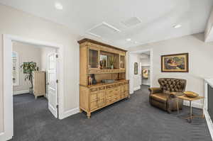 Living area featuring dark colored carpet