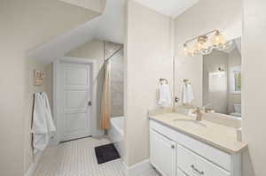 Full bathroom with vanity with extensive cabinet space, tile flooring, toilet, and shower / tub combo with curtain