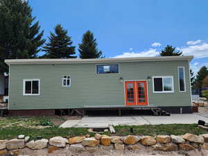 Rear view of house with a patio area and french doors