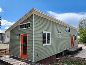 Back of property featuring a wooden deck