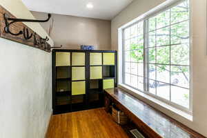 Interior space with a wealth of natural light and hardwood / wood-style floors