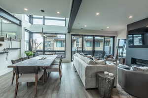 Living room with a healthy amount of sunlight and hardwood / wood-style flooring