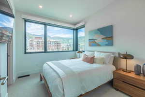 Carpeted bedroom with a mountain view