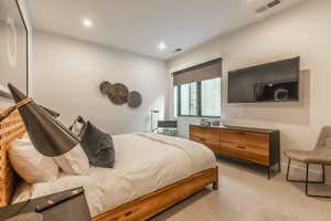 Bedroom featuring light colored carpet