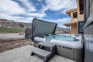 View of terrace featuring a hot tub