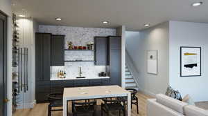 Kitchen with light hardwood / wood-style floors and sink