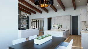 Dining space with beamed ceiling, sink, and light wood-type flooring