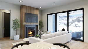 Living room with a mountain view, a large fireplace, and light wood-type flooring