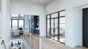 Hall with a chandelier and light hardwood / wood-style flooring