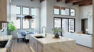 Kitchen with a wealth of natural light, sink, beamed ceiling, and light wood-type flooring