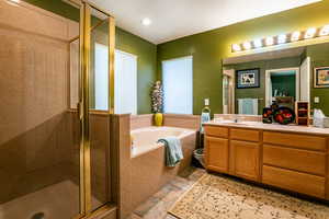 Bathroom featuring plus walk in shower, tile flooring, a textured ceiling, and vanity