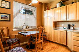 Dining room featuring ceiling fan and light hardwood / wood-style floors