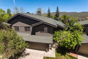 View of front facade featuring a garage and a mountain view