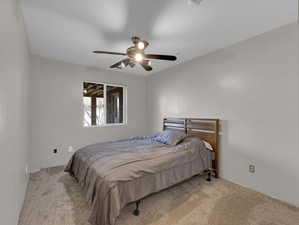 Carpeted bedroom with ceiling fan