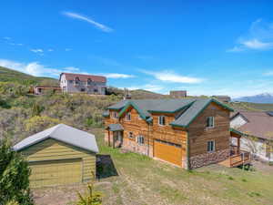 Exterior space featuring a deck with mountain view and a lawn