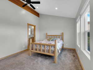 Carpeted bedroom with ensuite bath and ceiling fan