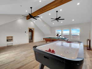 Game room with light hardwood / wood-style floors, ceiling fan, beam ceiling, high vaulted ceiling, and pool table