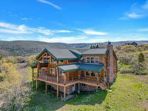 Back of property with a deck with mountain view