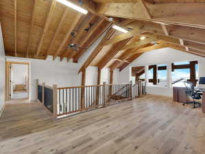 Bonus room with wooden ceiling, hardwood / wood-style floors, lofted ceiling with beams, and ceiling fan