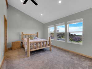 Bedroom with carpet flooring, ceiling fan, and lofted ceiling