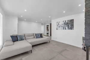 Living room featuring a textured ceiling and tile floors