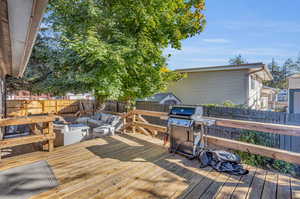 Wooden terrace with outdoor lounge area and area for grilling