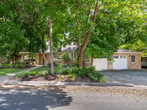 View of front of house. Heavily Wooded Yard.