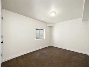 View of carpeted spare bedroom in basement