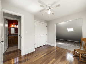 Entrance to 2nd floor bedroom, view of hall bathroom, and archway to vaulted area, ceiling fan and hardwood / wood-style flooring