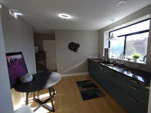 Kitchen with sink and light wood-type flooring