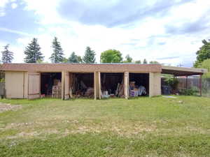 Exterior space featuring a yard and an outdoor structure