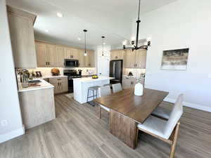 Dining room with an inviting chandelier and light hardwood / wood-style flooring