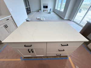 Interior space with light stone counters and white cabinetry