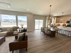 Living room featuring sink, a chandelier, a textured ceiling, and hardwood / wood-style flooring