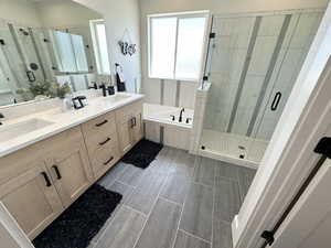Bathroom with plus walk in shower, dual bowl vanity, and tile patterned flooring