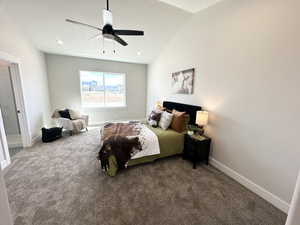 Carpeted bedroom featuring a textured ceiling, ceiling fan, and lofted ceiling