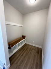 Mudroom with a textured ceiling and hardwood / wood-style floors