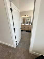 Bathroom featuring a textured ceiling, dual bowl vanity, and tile patterned floors
