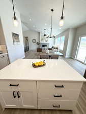 Kitchen featuring light hardwood / wood-style floors, vaulted ceiling, and a healthy amount of sunlight