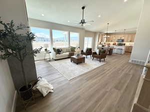 Living room featuring ceiling fan and light hardwood / wood-style flooring