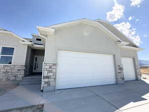View of side of property featuring a garage